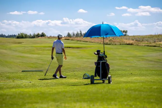 golfer on course with umbrella