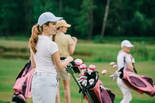women playing golf with pink bags